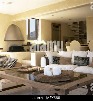 Open plan kitchen and dining area with wooden table and chairs Stock Photo