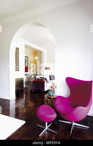 Pink Arne Jacobsen chair and footstool in modern room Stock Photo