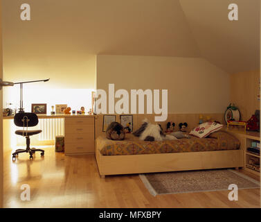 View of stuffed toys on a single bed Stock Photo