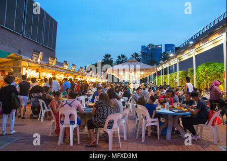 SINGAPORE - JAN 14, 2017 : People at popular food court in Singapore. Inexpensive food courts are numerous in the city so most Singaporeans dine out a Stock Photo