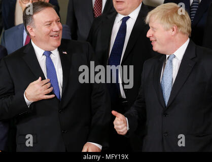 Brussels, Belgium. 27th Apr, 2018. British Foreign Secretary Boris Johnson (R) talks with U.S. Secretary of State Mike Pompeo at a family photo session during the NATO Foreign Ministers meeting at its headquarters in Brussels, Belgium, April 27, 2018. Credit: Ye Pingfan/Xinhua/Alamy Live News Stock Photo