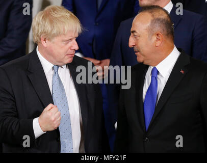 Brussels, Belgium. 27th Apr, 2018. British Foreign Secretary Boris Johnson (L) talks with Turkish Foreign Minister Mevlut Cavusoglu at a family photo session during the NATO Foreign Ministers meeting at its headquarters in Brussels, Belgium, April 27, 2018. Credit: Ye Pingfan/Xinhua/Alamy Live News Stock Photo