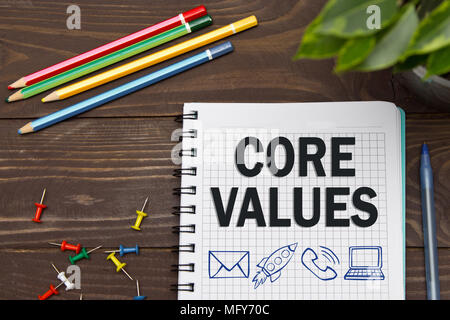 Notebook with a Business notes CORE VALUES on the office table with tools. Concept CORE VALUES with elements of infographics. Stock Photo