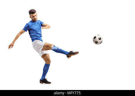 Full length portrait of a soccer player kicking a football isolated on white background Stock Photo
