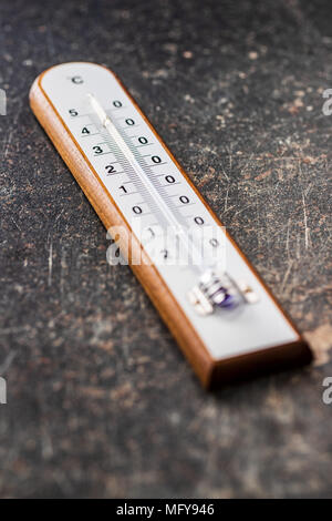 Wooden weather Thermometer on black background. Stock Photo