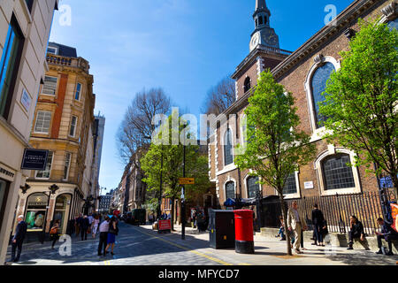 View of people walking on Jermyn Street on a summer day and side of St James's Church, Piccadilly, London, UK Stock Photo