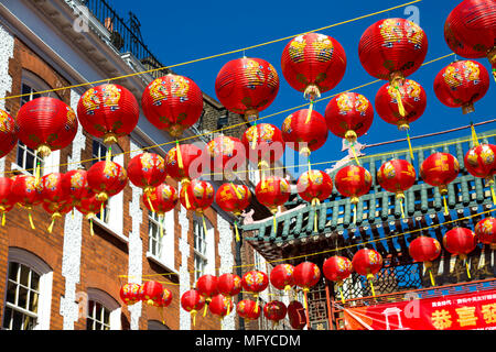 Red and yellow Chinese lanterns hanging above a street in China Town, London, UK Stock Photo