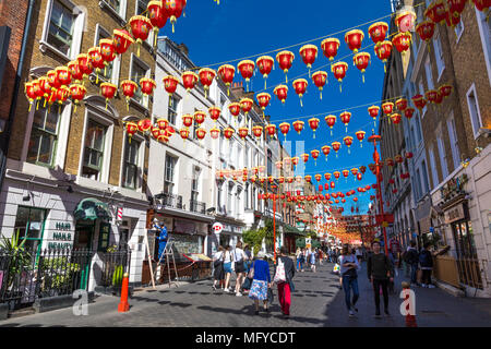 Red and yellow Chinese lanterns hanging above a street in China Town, London, UK Stock Photo