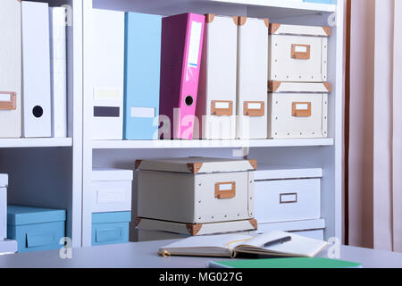 Modern office interior with laptop, chairs and bookcases Stock Photo