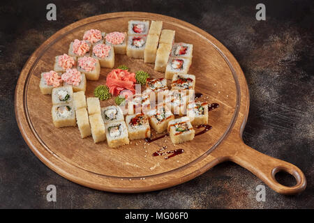 Big set of japanese food sushi maki rolls on wooden board Stock Photo