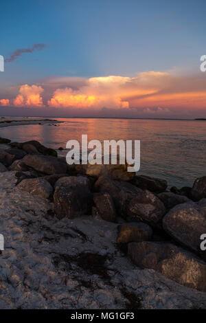 Distant thunderstorms over water during sunset, Boca Grande FL Stock Photo