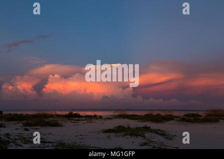 Distant thunderstorms over water during sunset, Boca Grande FL Stock Photo
