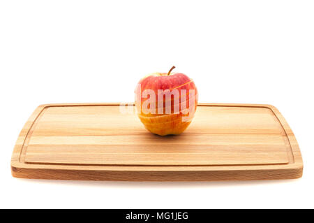 Red and yellow apple sliced on a cutting board Stock Photo