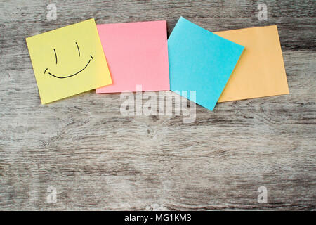 Colored paper stickers on wooden table Stock Photo