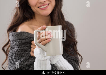 Portrait of brunette woman wearing gray cardigan Stock Photo
