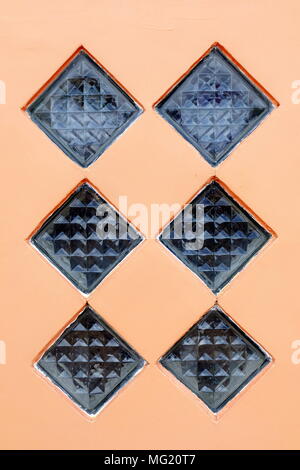 Glass Block on Flesh Tone Concrete Wall Background. Stock Photo