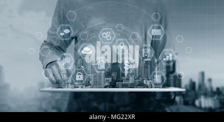 a man using digital tablet and interface online application icons Stock Photo