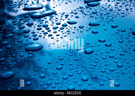 water drops on blue car bonnet Stock Photo