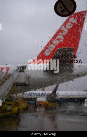 Low-cost flight from Easy Jet air company lands by a rainy weather at Lisbon airport, Potugal Stock Photo