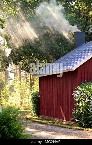 Sauna is warming up. Sun rays are coming through smoke Stock Photo