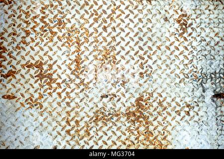 White Peeling Paint  on Diamond Plate Wall. Stock Photo
