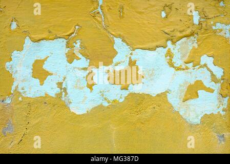 Yellow Peeling Paint on Concrete Wall Background. Stock Photo