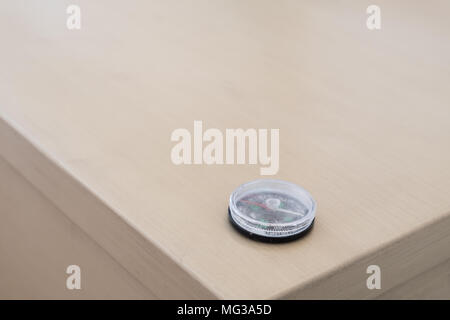 Antique compass close up on wood background. Compass. Navigation equipment, metal gauge Stock Photo