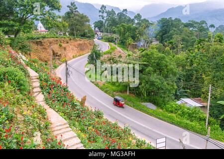 Landscapoe Sri Lanka with a small stupa, a flower garden, a raod and mountains Stock Photo