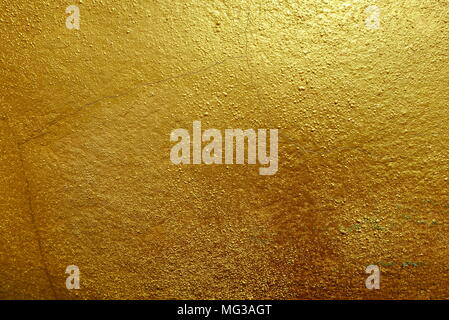 Dark Golden Paint on Stone Background. Stock Photo