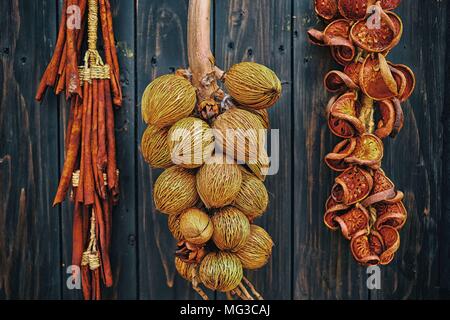 Young Dried Coconut hanging on Wooden Wall. Stock Photo