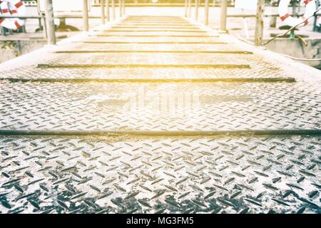 Diamond Plate Pathway to Pier Background with Light Leak. Stock Photo