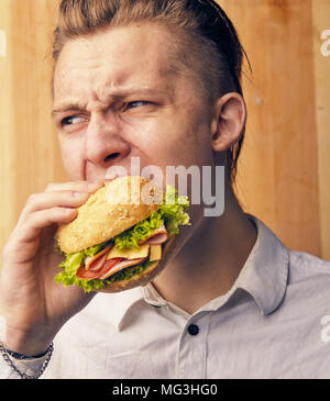 the young guy is really trying to burger Stock Photo