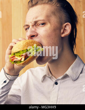 the young guy is really trying to burger Stock Photo