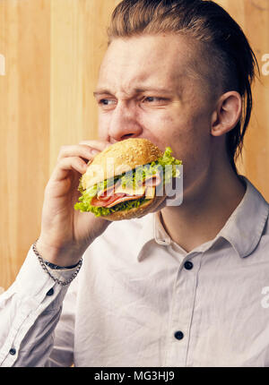 the young guy is really trying to burger Stock Photo