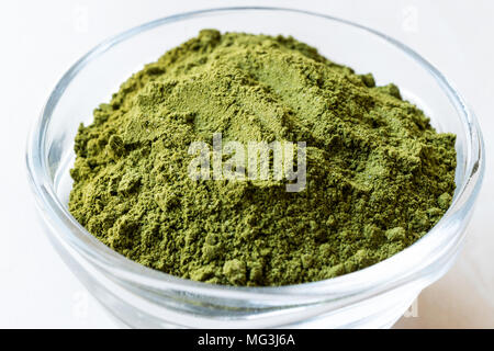 Green Matcha Tea Powder in Glass Bowl. Organic Product. Stock Photo