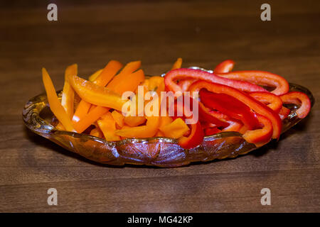 sliced orange and red bell peppers served in a dish Stock Photo