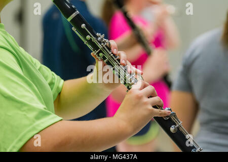 the hands of a musician playing a clarinet Stock Photo