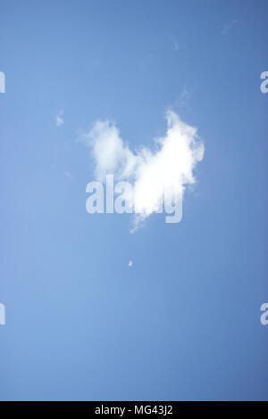 Real Heart Shaped Cloud with Moon on Clear Blue Skies Stock Photo