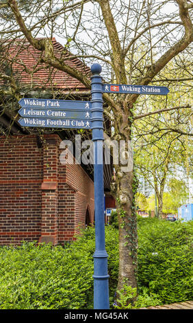 Direction sign to attractions, amenities and facilites in Woking, Surrey, UK: Woking Park, Leisure Centre, Woking Football Club, Woking Station Stock Photo