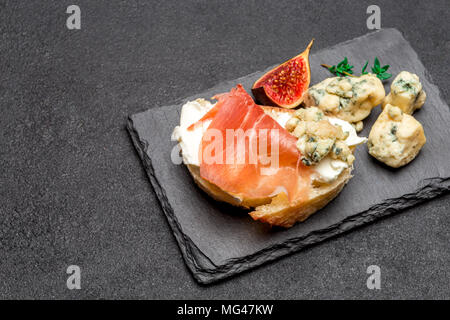 Bruschetta with ham, blue ceese and fresh figs Stock Photo