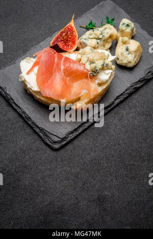 Bruschetta with ham, blue ceese and fresh figs Stock Photo