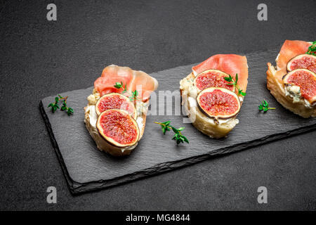 Bruschetta with ham, blue ceese and fresh figs Stock Photo