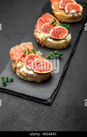 Bruschetta with ham, blue ceese and fresh figs Stock Photo