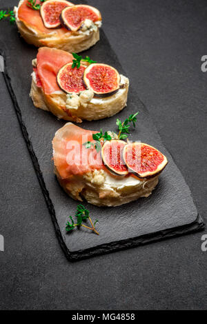 Bruschetta with ham, blue ceese and fresh figs Stock Photo