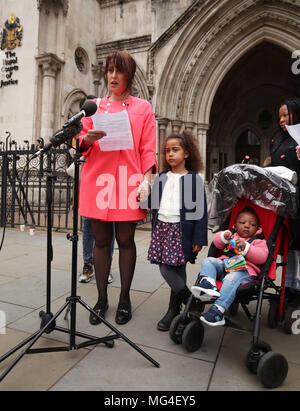 Alina Dulgheriu, 34, a representative for campaign group Be Here For Me,  with her six-year-old daughter Sarah, speaks to the media outside the Royal  Courts of Justice in London, after filing a