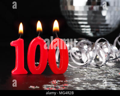 Red candles showing Nr. 100  Abstract Background for birthday or anniversary party. Stock Photo