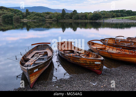 Wooden rowing boats on the shore at Keswick landing stage at dawn on Derwent Water in the Lake District National Park, Cumbria, England Stock Photo