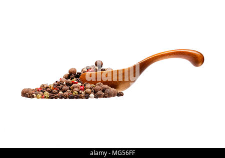 Mix of dried peppers in the wooden spoon, isolated on white background. Stock Photo