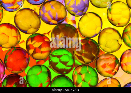 abstract clear round glass nuggets / pebbles on frosted glass Stock Photo