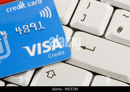 Visa card credit card on a keyboard with enter key. To illustrate online internet payment shopping concept using a credit card. England UK Britain Stock Photo